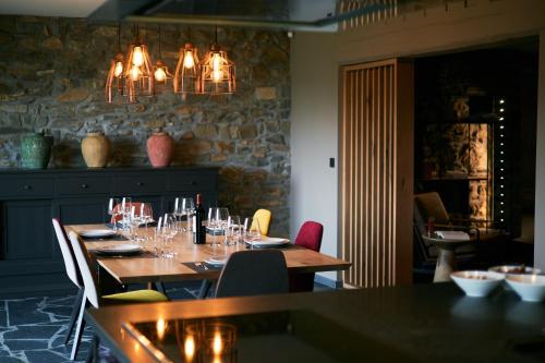 a dining room with a table with wine glasses on it at OKLM in Stavelot
