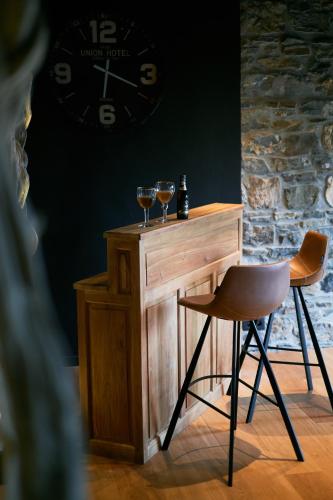 a bar with two wine glasses on top of it at OKLM in Stavelot