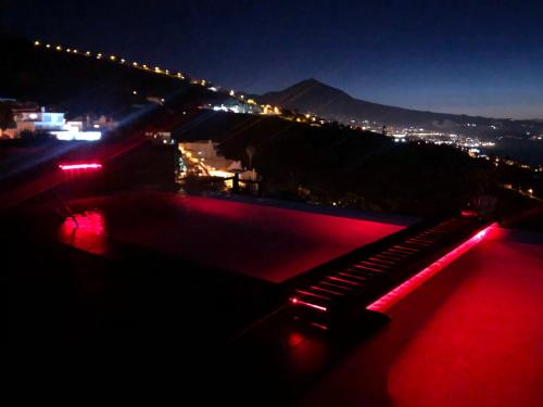 a view of a bridge at night with red lights at Apartamento Teide Piscina Climatizada in Sauzal