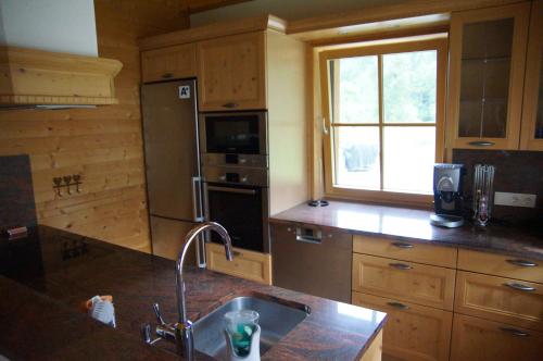 a kitchen with a sink and a refrigerator at W & S Executive Apartments - Hallstatt II in Hallstatt