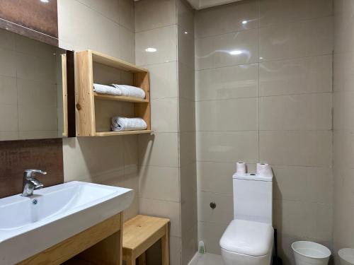 a bathroom with a white sink and a toilet at Lovely city center flat near the old Medina in Casablanca