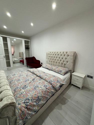 Bradenham的住宿－Cheerful 2 Bedroom Bungalow fully Furnished，一间卧室配有一张特大号床和一把椅子