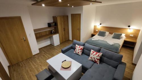 a living room with a couch and a bed at Willa Kania in Szczawnica
