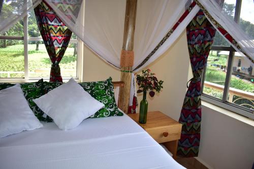 A bed or beds in a room at Kilimanjaro Accommodation