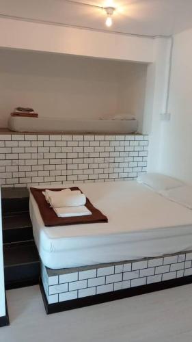 a bed in a room with a brick wall at Perhentian Bay Chalet in Perhentian Island