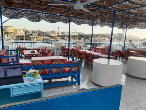 a restaurant on a ship with tables and chairs at Airkela Nuba Dool2 in Aswan