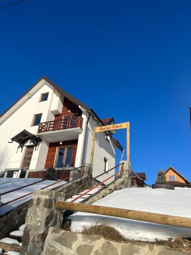 a building with snow in front of it at Sunčani vrhovi in Raška