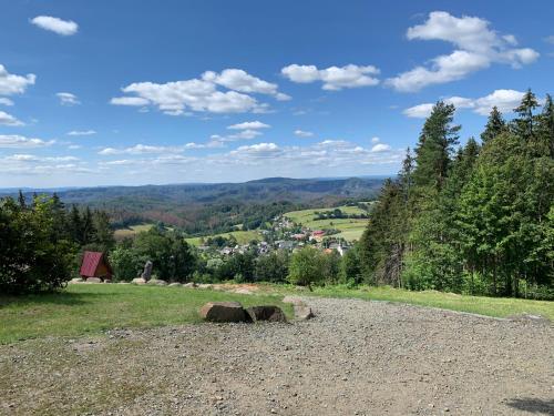 a hill with a view of a town in the distance at Gasthof zur Hoffnung in Hinterhermsdorf