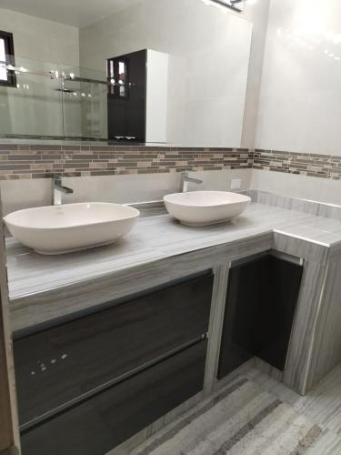 a bathroom with two sinks and a large mirror at CORONADO, LAS BRISAS in Playa Coronado