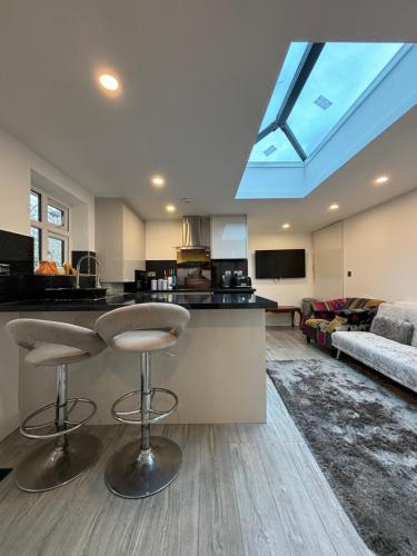 a kitchen and living room with a skylight at Newly Build 2BR Property with free parking in High Wycombe