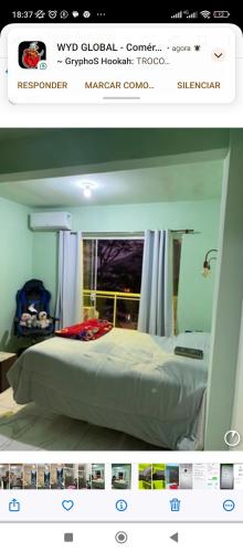a picture of a bedroom with a bed with a window at Casa de veraneio garatucaia in Angra dos Reis