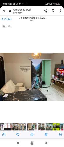 a picture of a room with a bed and a television at Casa de veraneio garatucaia in Angra dos Reis