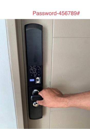 a hand unlocking a door with a remote control at Alea Residences in Manila