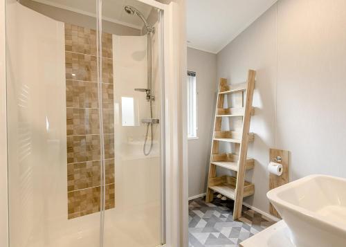 a bathroom with a shower and a sink at Grange Leisure Park in Mablethorpe