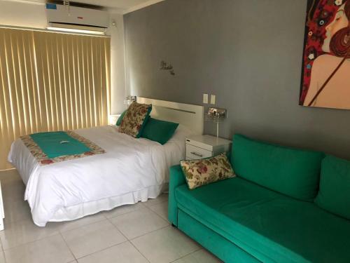 a living room with a couch and a bed at DINASTIE APART HOTEL in Chajarí