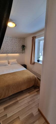 1 dormitorio con cama y ventana en Sifferbo Stugby en Sifferbo