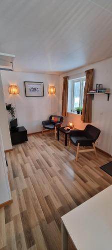 a living room with two couches and a table at Sifferbo Stugby in Sifferbo
