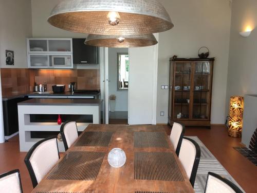 a dining room with a table and a kitchen at VILLA ANNA in Cerny Dul