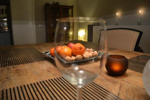 a plate of fruit on a table with a wine glass at VILLA ANNA in Cerny Dul