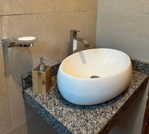 a bathroom with a white sink on a counter at Sacred Valley House in Calca