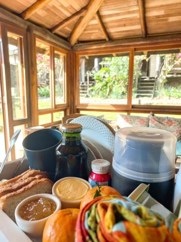 a table with bread and other food on it at Pousada Sentiero - Praia do Rosa in Praia do Rosa