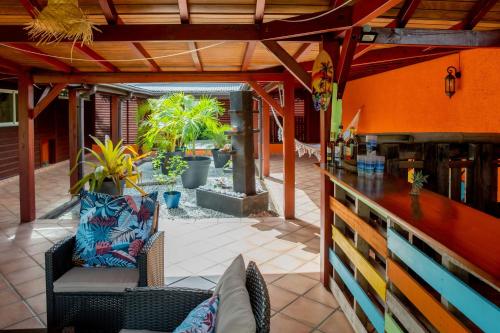 an outdoor patio with a couch and a bar at La Villa Holiday, 10 personnes, piscine patio bar terrasse in Sainte-Rose