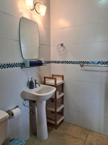 a bathroom with a sink and a mirror at Casapreciosa-LasLajas in Las Lajas