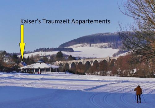 a person on skis in the snow near a bridge at Kaiser's Traumzeit Appartements Typ1 - ideal für mehrere Paare! in Willingen