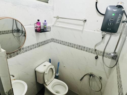 a small bathroom with a toilet and a sink at Sehijau Homestay Kangar in Kangar