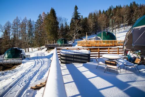 a group of tents and a table in the snow at BUNNY GLAMP in Korbielów