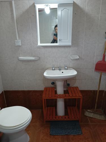 a bathroom with a sink and a toilet and a mirror at Casa para 4 personas in San Carlos de Bariloche