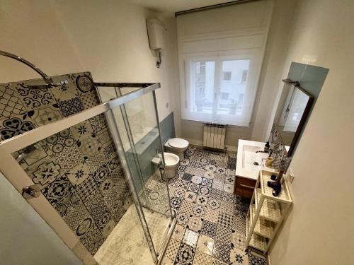 a bathroom with a glass shower and a toilet at Charm & History in Trieste in Trieste