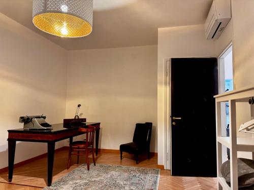 an office with a desk and a phone on a table at Charm & History in Trieste in Trieste