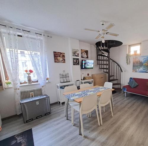 a living room with a dining room table and chairs at Appartamento Al Ponte adiacente al parco, vicino all'ospedale e centro in Trento