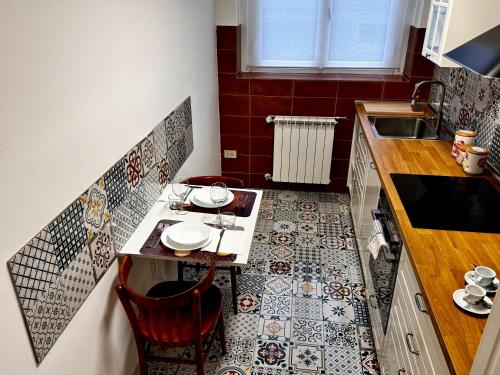 a small kitchen with a table with plates on it at Charm & History in Trieste in Trieste