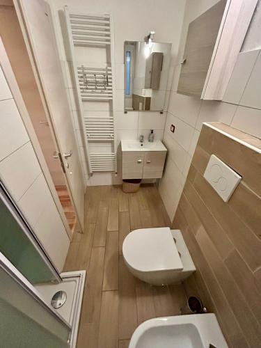 a small bathroom with a toilet and a sink at RESIDENCE ZAR 4 in Trieste
