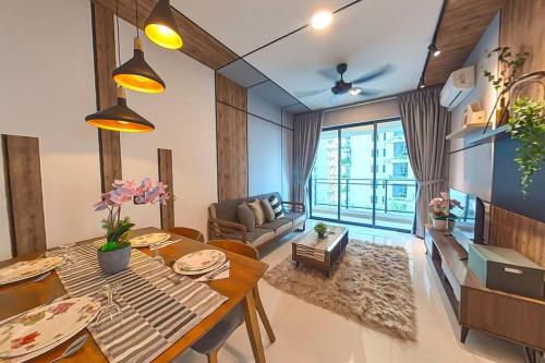 a living room with a table and a couch at ForestCity StarView Bay Condo in Kampong Pok Kechil