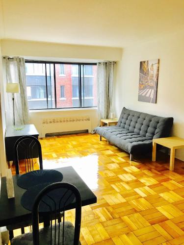 a living room with a couch and a table at Stylish Montreal Apartment: Comfortable Stay in the Golden Square Mile in Montreal