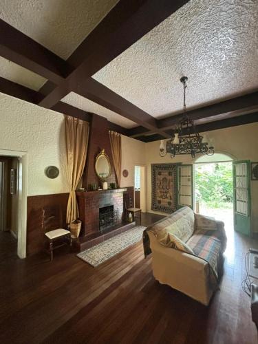 a living room with a couch and a fireplace at Muqui 91 Guesthouse in Teresópolis