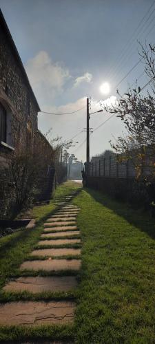 a stone path with the sun in the background at La Petite Taupe in Saint-Omer