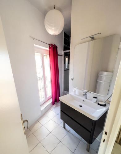une salle de bain avec un lavabo et un miroir dans l'établissement Résidence Touristique Béziers Hyper Centre : A la Ville de Florence, à Béziers
