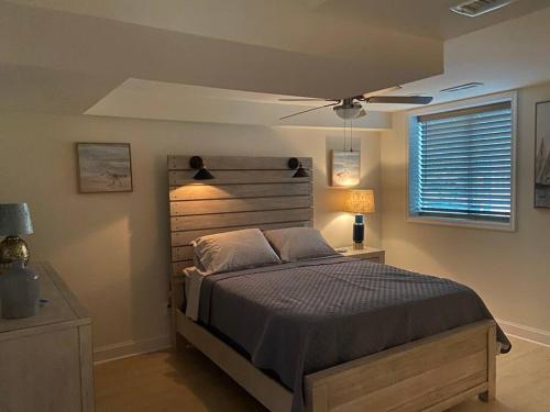 a bedroom with a bed and a ceiling fan at The Retreat at Davis Mill in Germantown