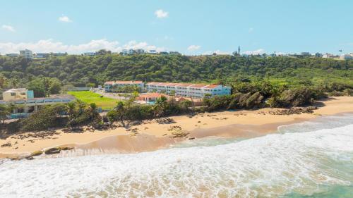 an aerial view of the beach and the ocean at Golden Dream Villas 306/A in Isabela