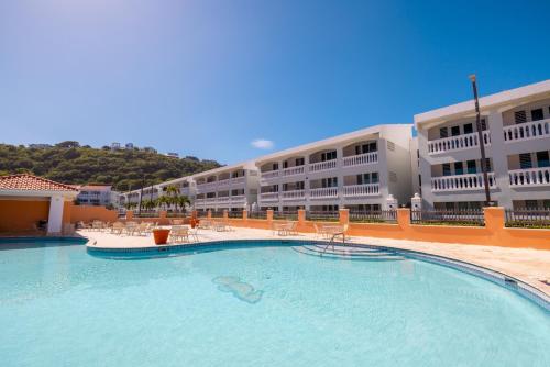 a large swimming pool in front of a building at Golden Dream Villas 306/A in Isabela