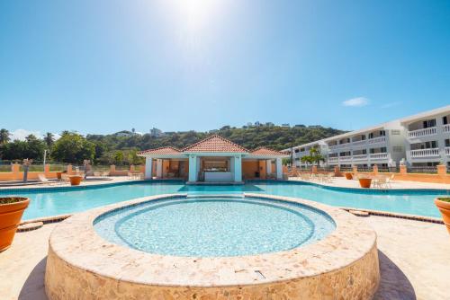 a large swimming pool with a building in the background at Golden Dream Villas 306/A in Isabela