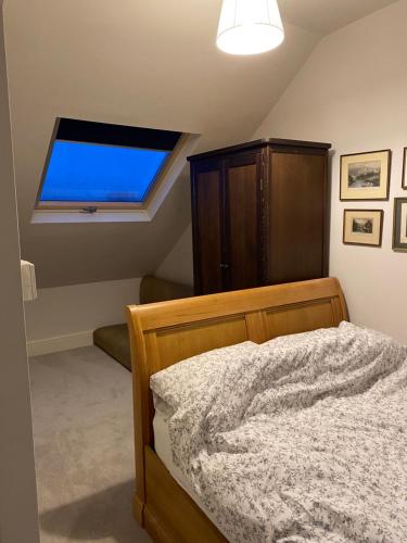 a bedroom with a bed and a large window at Castle Room in Windsor