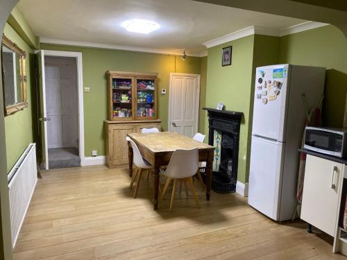 a kitchen with a table and a refrigerator at Castle Room in Windsor