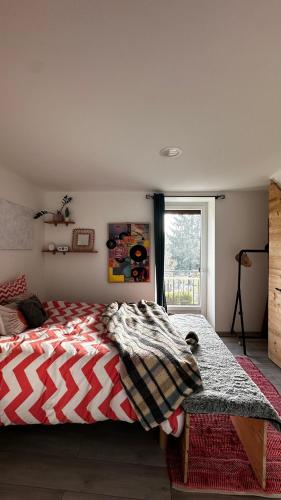 a bedroom with a bed with a blanket on it at Chez Marie en Savoie in La Ravoire