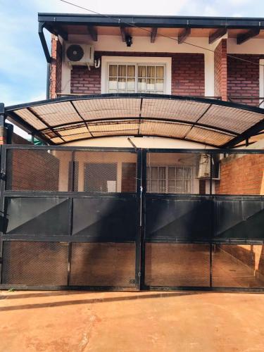 an open garage door with a gate in front of a building at Joly in Wanda