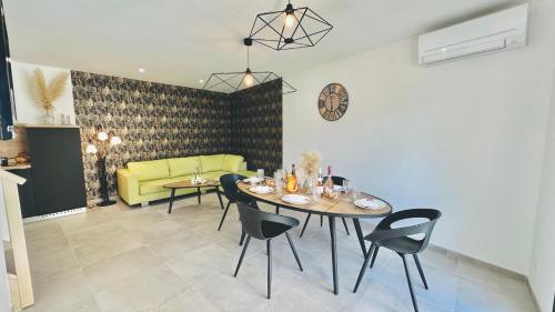 a living room with a table and a yellow couch at Les Gîtes de la Chapelle 4 in Vauvert